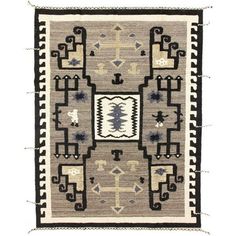 an old rug with black and white designs on it