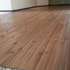 an empty room with hard wood floors and white walls