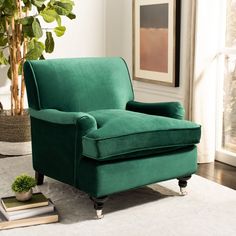 a green chair sitting on top of a white rug next to a potted plant