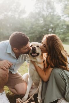 a man and woman are kissing their dog