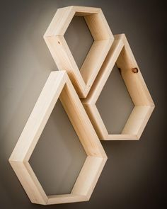 three wooden hexagonal shelves on the wall