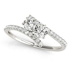 a cushion cut diamond engagement ring with pave set shoulders