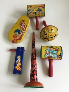 several children's toys are lined up on a white surface, including toothbrushes and other items