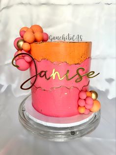 a pink cake with orange and gold decorations on it's top that says dance