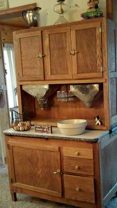 an old fashioned kitchen with wooden cabinets and granite counter tops