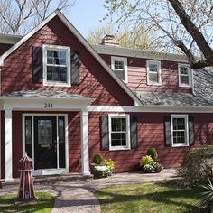 a red house with white trim and black shutters