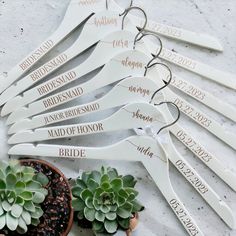 the bride and groom hangers are decorated with succulents