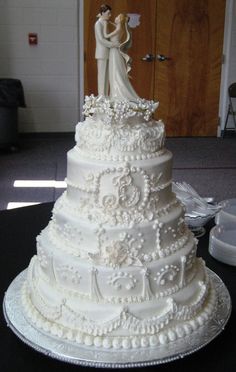 a wedding cake with white frosting on top