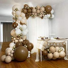 a baby shower is decorated with balloons and streamers