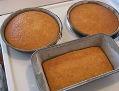 three pans filled with cake sitting on top of a stove