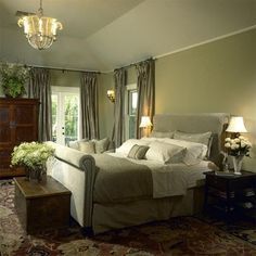 a bedroom with a large bed and chandelier