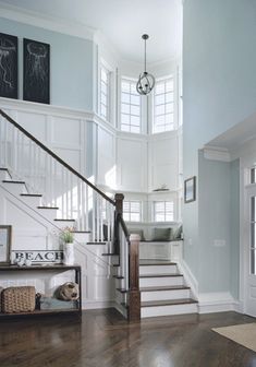 the stairs in this house have been painted blue with white trim and wood flooring