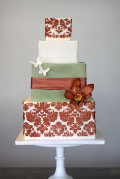 a three tiered cake with flowers on top