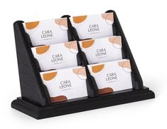 four business cards in a holder on a white background with the name cara lezonene