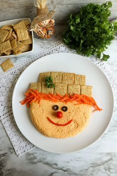 a white plate topped with crackers and a face