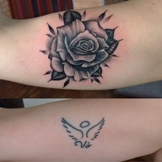 two tattoos with roses and wings on their arms, one is black and the other is white