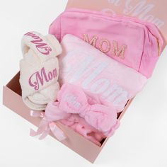 a pink gift box filled with personalized items and a mom's mitt