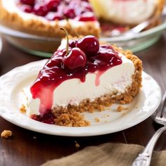 a slice of cheesecake with cherries on top