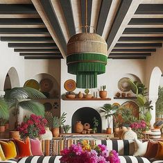 a living room filled with lots of furniture and flowers on top of striped couches