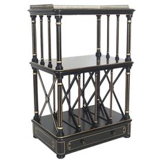 a black and gold shelf with two drawers on each side, in the shape of a cage