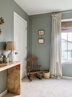 a rocking chair sits in front of a window