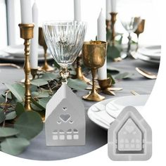 a table with candles, plates and silverware on it