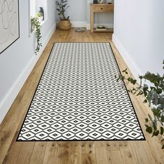 a white and black area rug in a hallway