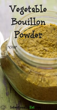 a jar filled with yellow powder sitting on top of a wooden table