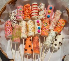 a basket filled with lots of different types of donuts on top of skewers