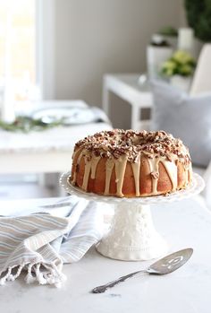 a cake sitting on top of a white cake plate