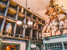 a store with lots of wooden shelves filled with books and vases in it's center