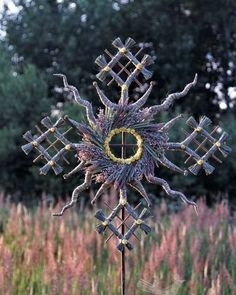 a metal snowflake in the middle of a field