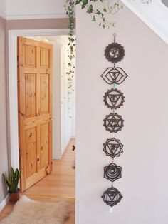 an entry way with plants and decorations on the wall