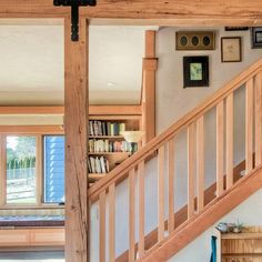 there is a cross on the wall next to some bookshelves in this house