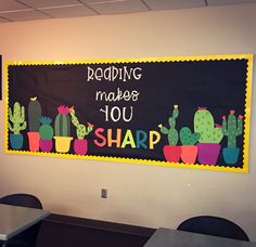 a chalkboard with writing on it that says reading makes you sharp and cactuses