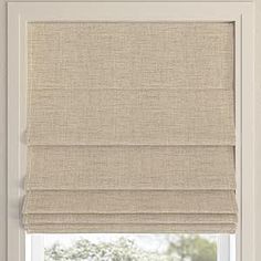 a beige roman blind in front of a window