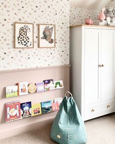 a child's room with polka dot wallpaper and bookshelf in the corner