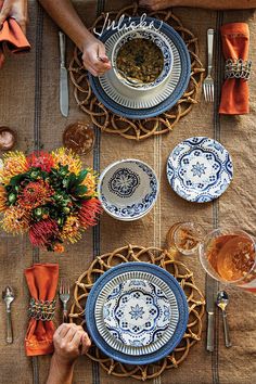 people sitting at a table with plates and silverware