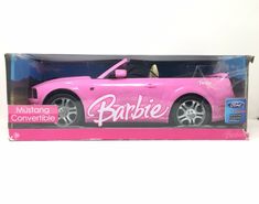 a pink toy car with the word barbie written on it