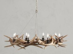 a chandelier with antlers hanging from it's sides and four lights on each side