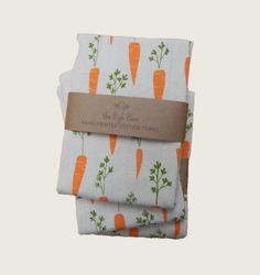 three napkins with carrots printed on them