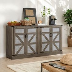 a sideboard with glass doors and baskets on top in a living room next to a wall