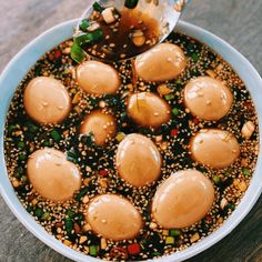 a bowl filled with sesame seeds and some kind of food on top of the table