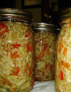 three jars filled with food sitting on top of a table