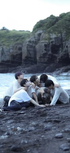 group of people huddled together on the beach