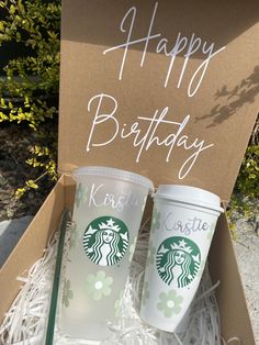 two starbucks cups in a box with the words happy birthday written on them