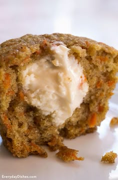 a close up of a muffin on a plate with ice cream in the middle