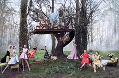 a group of people sitting around a tree house