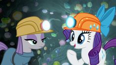 two little ponys wearing hard hats standing next to each other