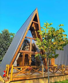 a - frame cabin in the middle of a field